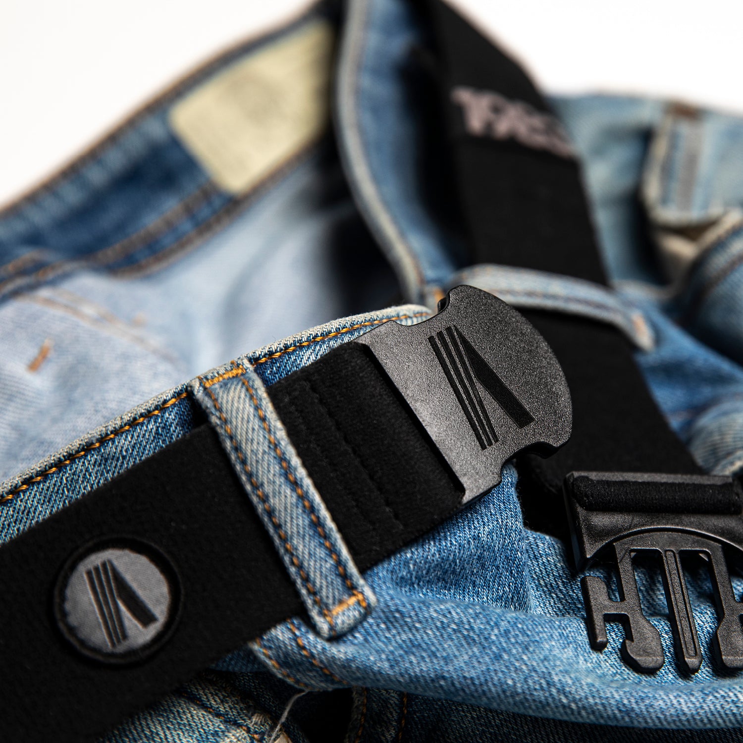 midnight black performance wear thin belt wrapped around blue jeans